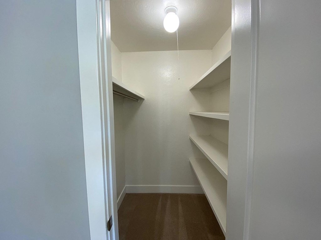 A long hallway with a light on the ceiling.