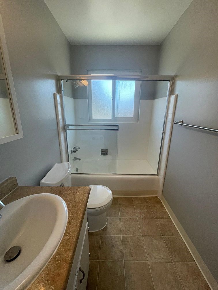 a bathroom with a sink toilet and a shower
