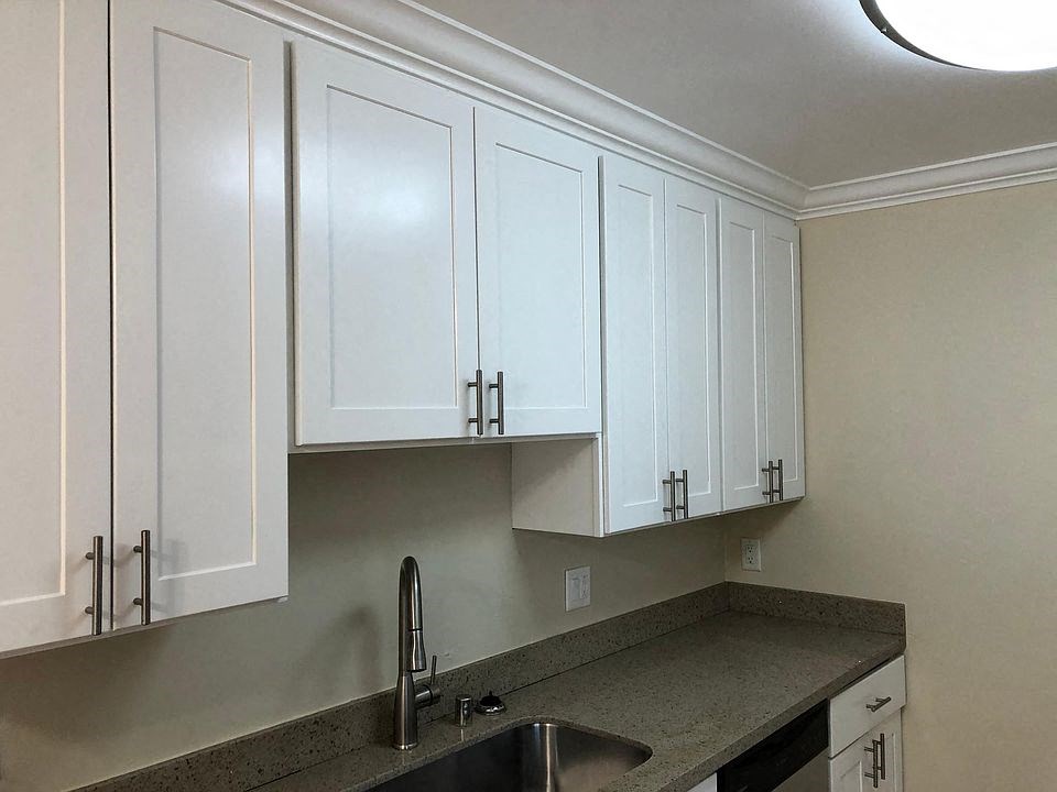 A view of the kitchen sink and cabinets