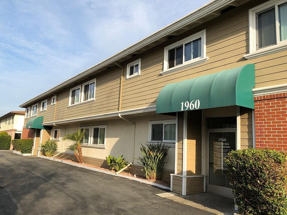 the front of a building with a green awning