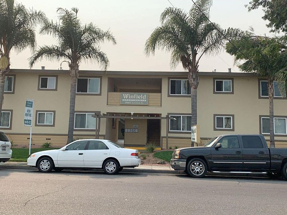 two cars parked in front of an apartment building