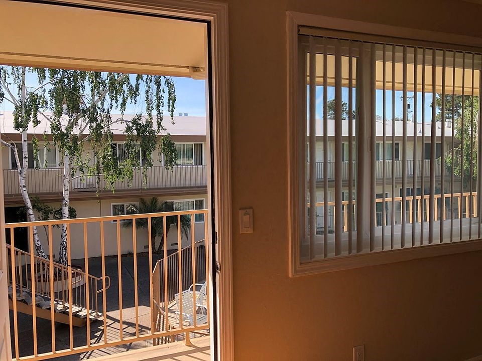 a view of a balcony and a door with a window