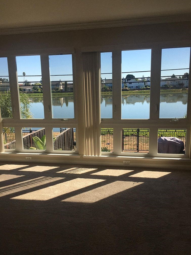 a living room with windows overlooking a body of water