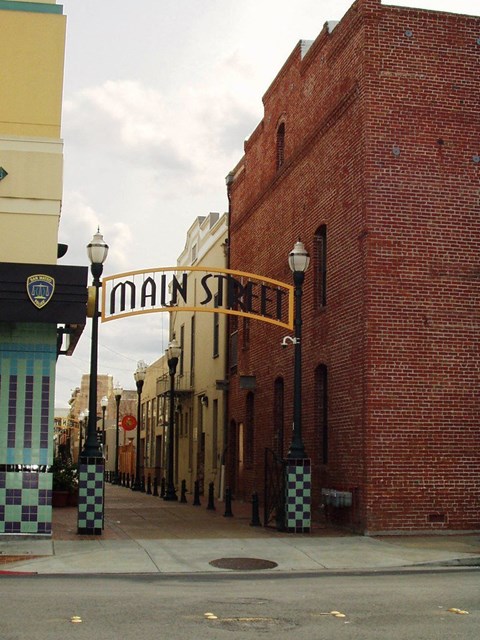 A street view of Main Street with a brick building on the right.