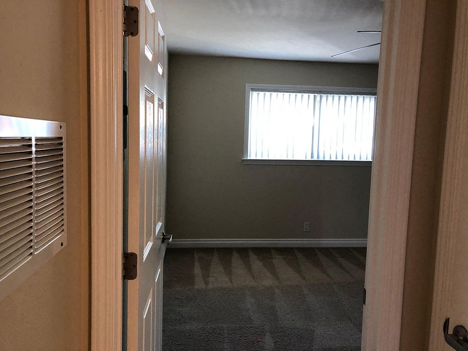 an empty room with a window and a door