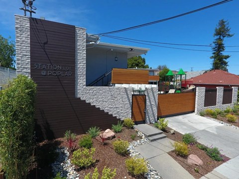 a view of the front of a house with a staircase and a garden