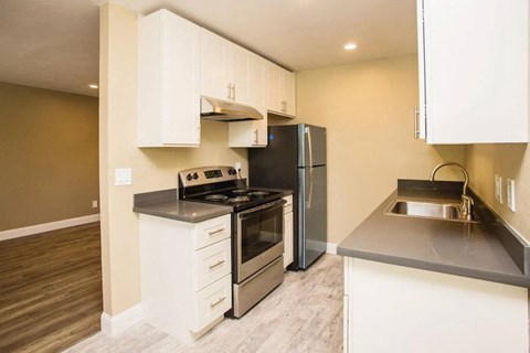 a kitchen with stainless steel appliances and white cabinets