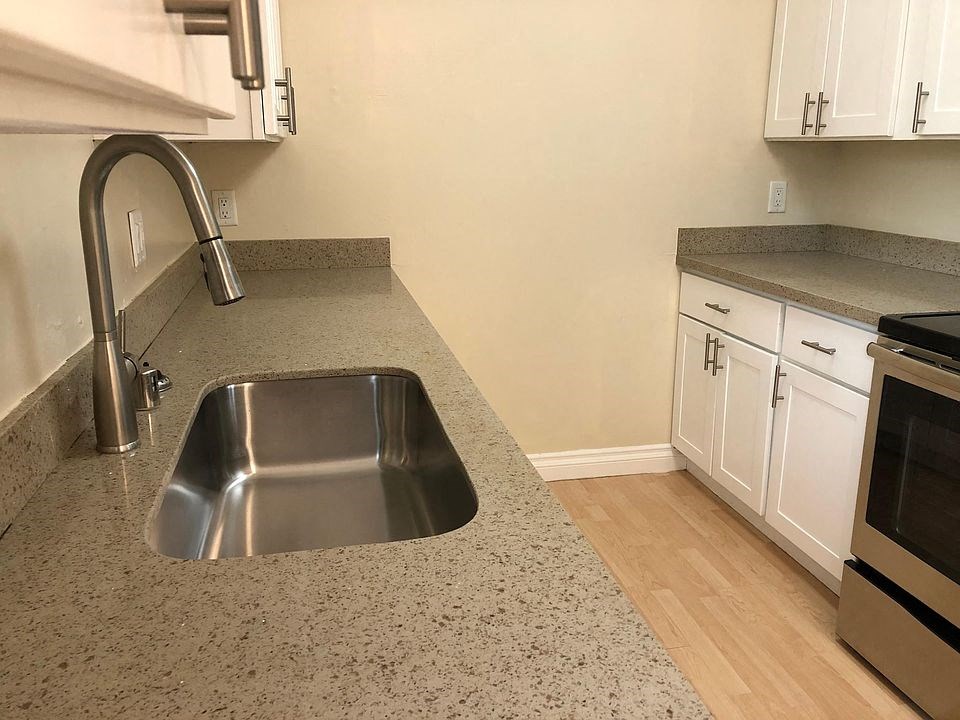 a kitchen with a stainless steel counter top and a sink