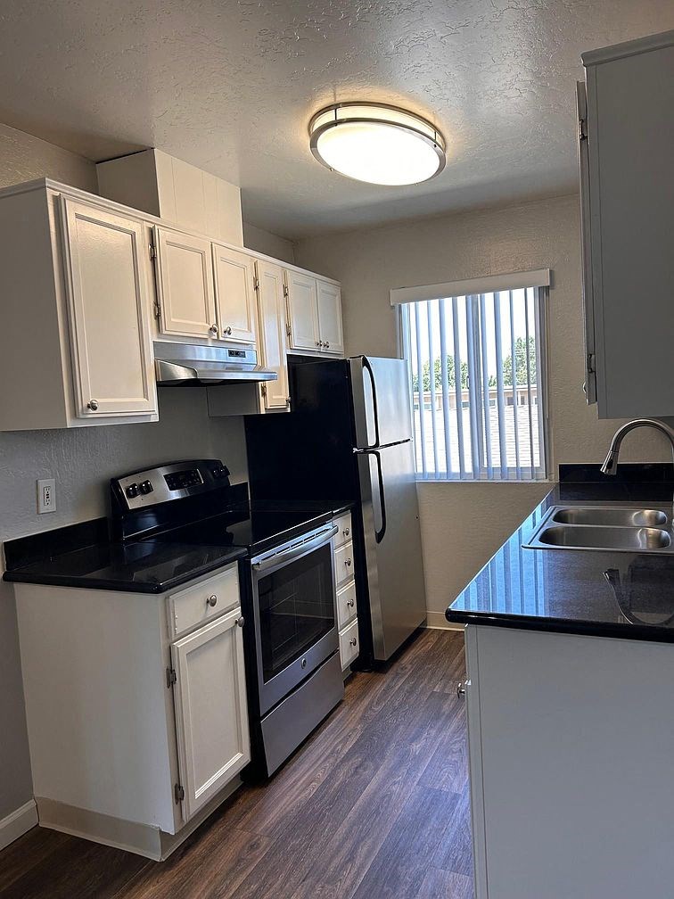 a kitchen with a stove refrigerator and sink