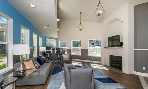 a living room with a couch and chairs and a fireplace