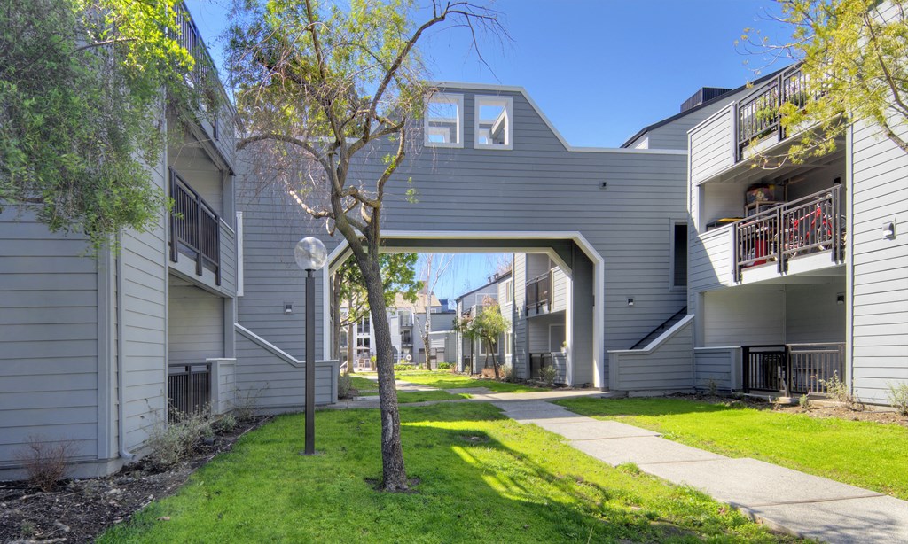 a view of a building with a walkway between two houses