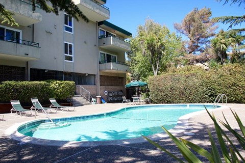 a swimming pool in front of an apartment building