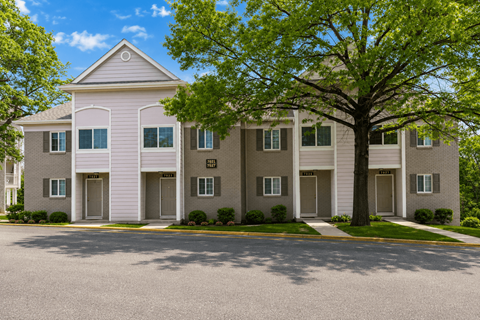 Townhouse with trees in front of it.