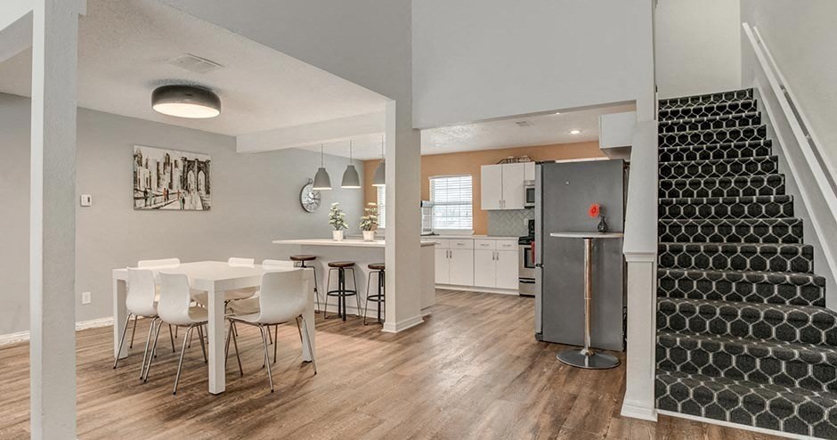 A dining area with a white table and chairs is shown.