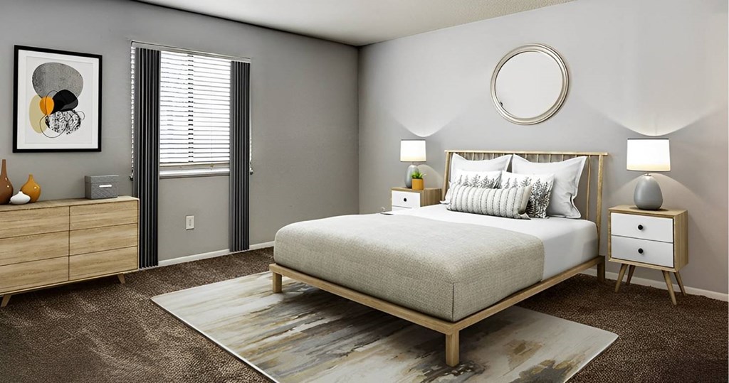 A bedroom with a bed, nightstands, and a rug.