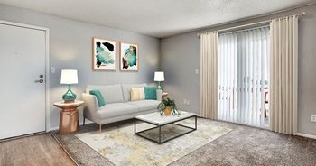 A living room with a white couch, a glass coffee table, and two lamps.