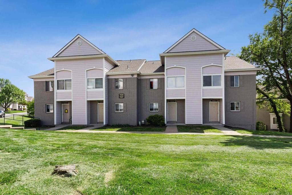A large, two-story house with a grey and white exterior.