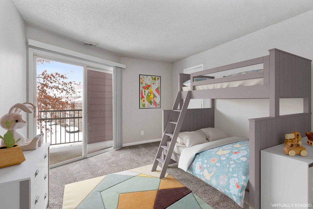 A child's bedroom with a bunk bed and a ladder.