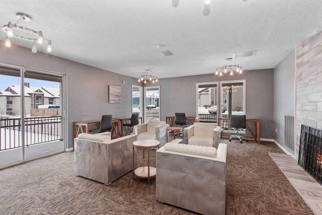 A spacious living room with a large couch and a fireplace.