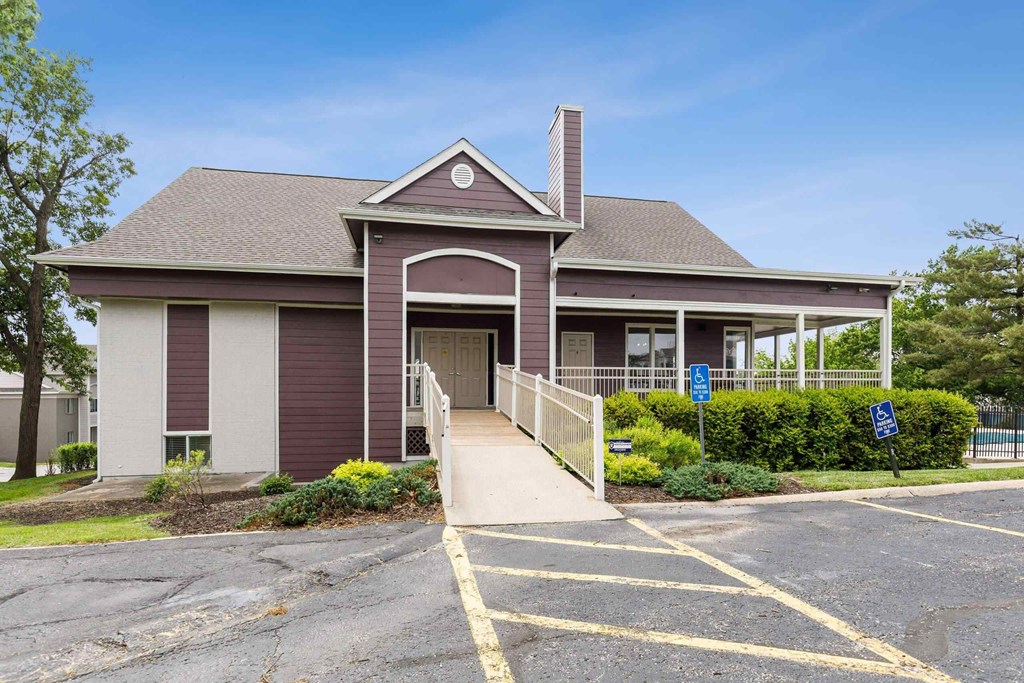 A building with a parking lot in front of it.