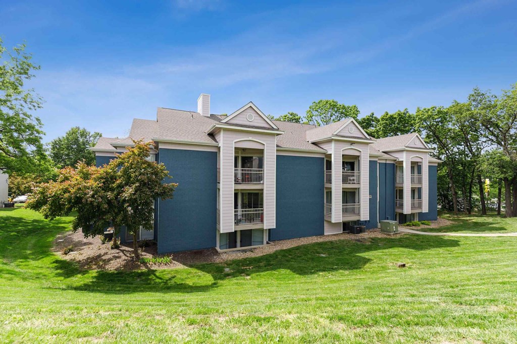A blue house with white trim and a large front porch.