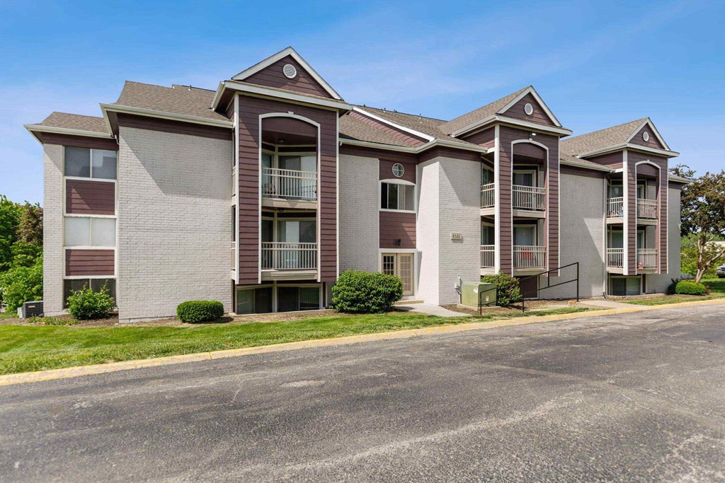 A large apartment complex with multiple balconies and doors.