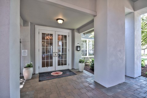 Covered entryway with glass french doors at Rosemeade Apartments, California
