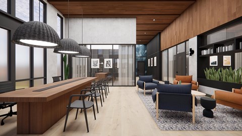 A modern office space with a long wooden desk and chairs, a blue sofa, and a large window with a view of the sky.