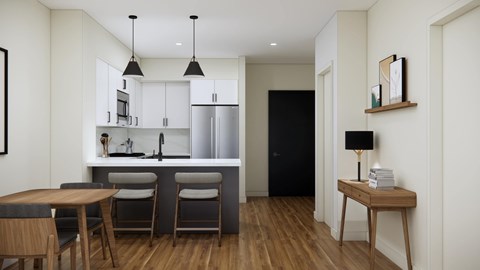 A modern kitchen with a dining table and chairs.