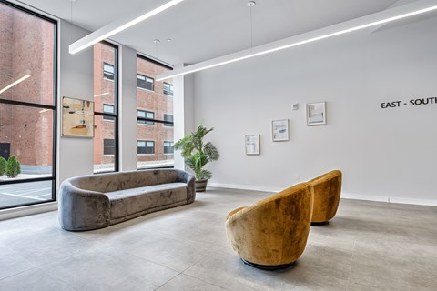 A modern living room with a large couch and two chairs.