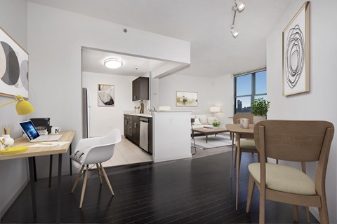 A modern kitchen with a dining table and chairs.