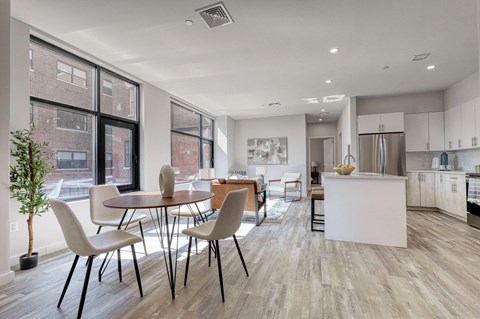 A modern kitchen with a dining table and chairs.