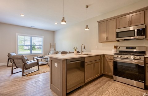 A kitchen with wooden cabinets and stainless steel appliances.