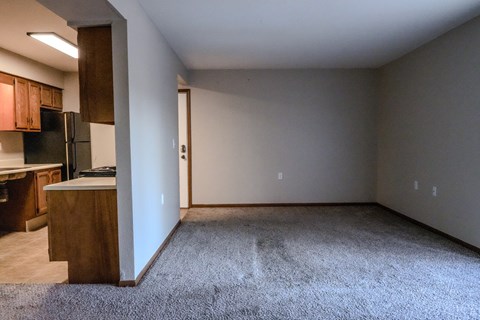 A kitchen with a refrigerator and a countertop is visible.
