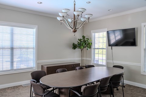 A dining room with a round table and chairs.