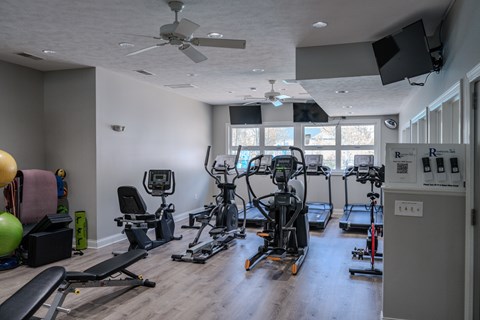 Fitness center with cardio and strength equipment at The Vue at Rivertown Park Townhomes Apartments, Wyoming, Michigan