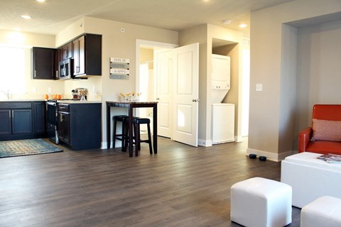 A kitchen with dark wood cabinets and a black refrigerator.