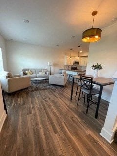 A living room with a white couch and a wooden floor.