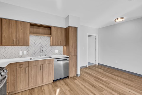 A kitchen with wooden cabinets and a white countertop.