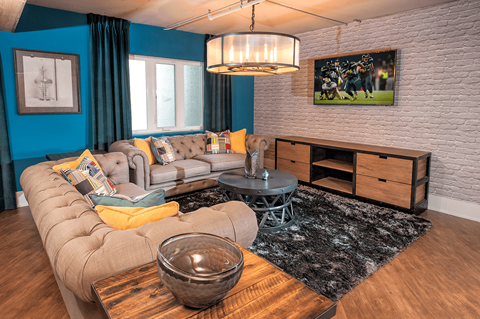 A living room with a grey sofa and a wooden coffee table.