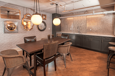 A dining room with a wooden table and chairs.
