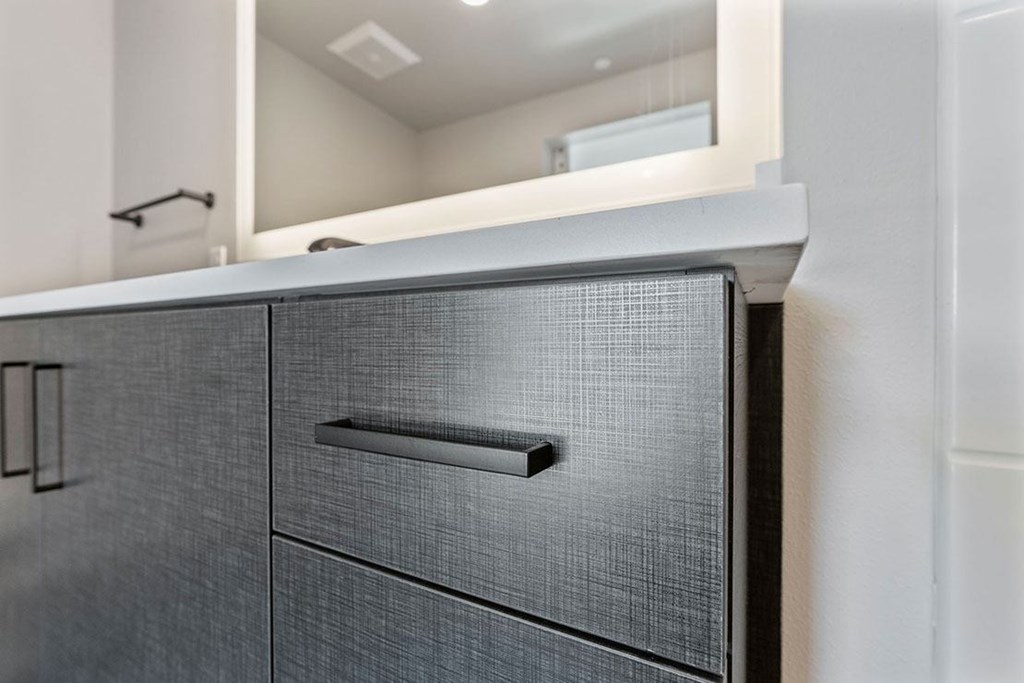 A black filing cabinet with a handle and two drawers is shown