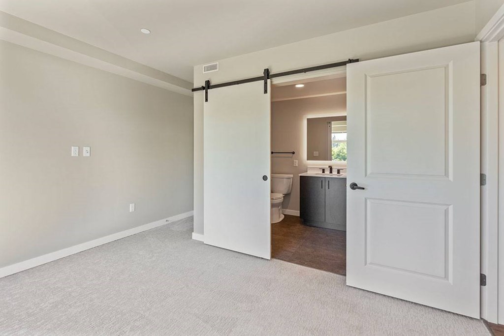 A white door is open to a bathroom