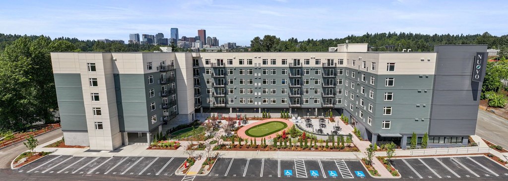 A large, modern building with a parking lot in front