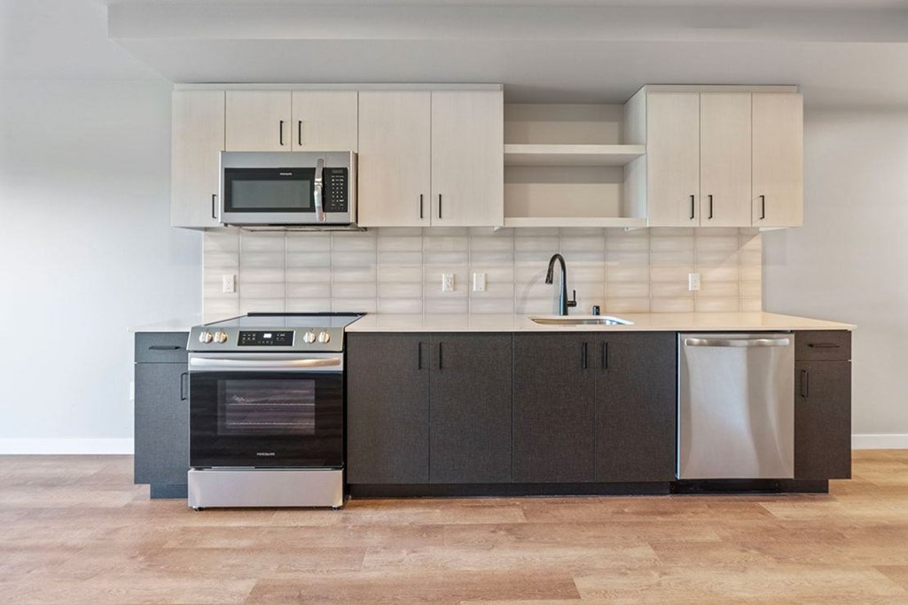 A modern kitchen with a stainless steel dishwasher and oven