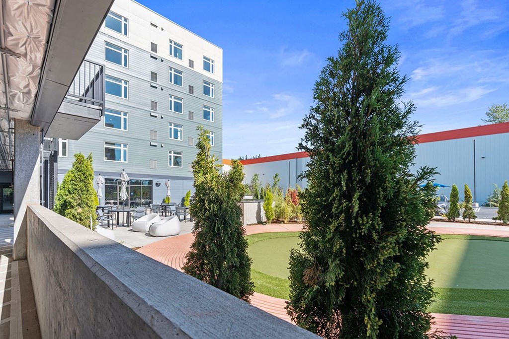 A modern building with a green lawn in front