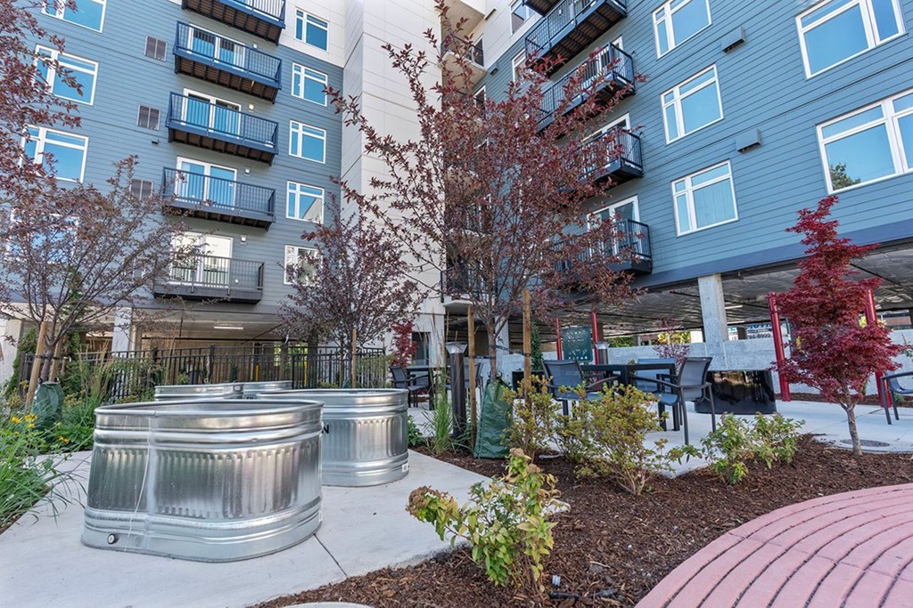 A modern apartment complex with a courtyard and trees