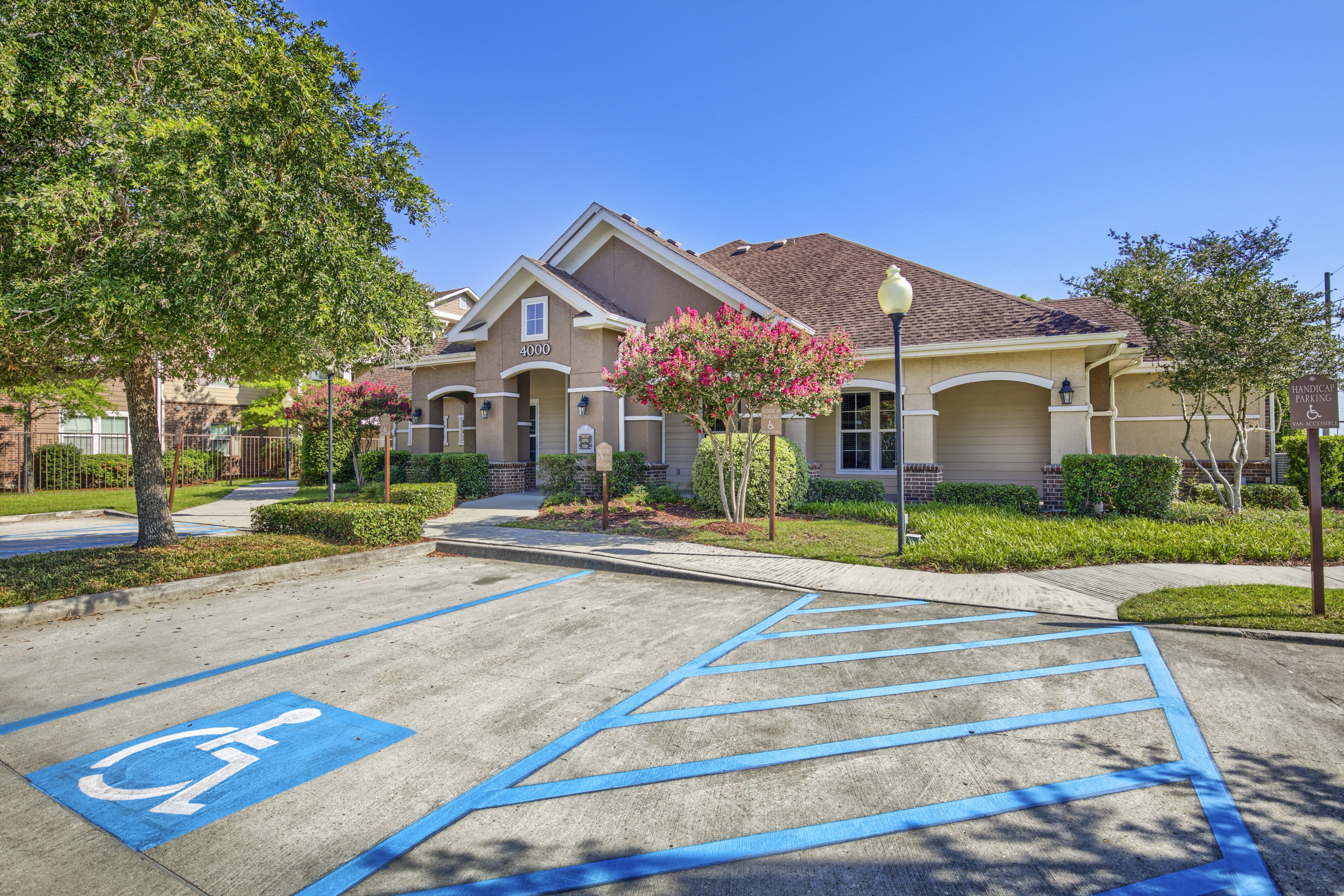 A parking lot with a handicap parking space in front of a building.