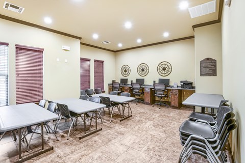 A conference room with a long table, chairs, and a plaque on the wall.