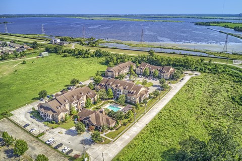 A bird's eye view of a residential area with houses and a swimming pool.